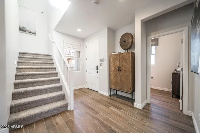 a view of a hallway with wooden floor and entryway