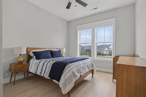 a bed room with a bed and a chair