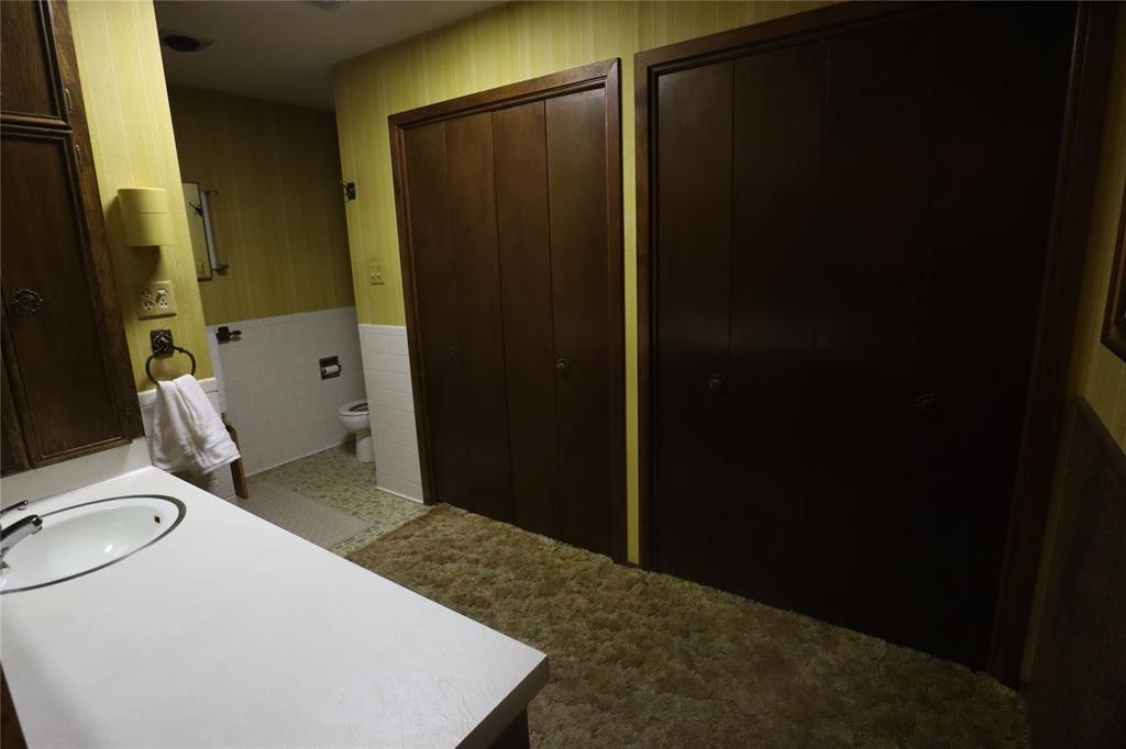 301 Travis Street Ranger, TX 76470 - Photo 15 of 31 a bathroom with a sink and a toilet