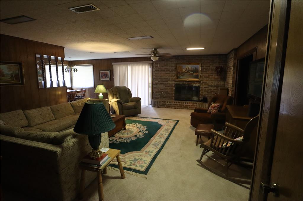301 Travis Street Ranger, TX 76470 - Photo 18 of 31 a living room with furniture a flat screen tv and a window
