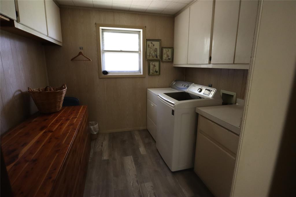 301 Travis Street Ranger, TX 76470 - Photo 22 of 31 a utility room with wooden floor washer and dryer