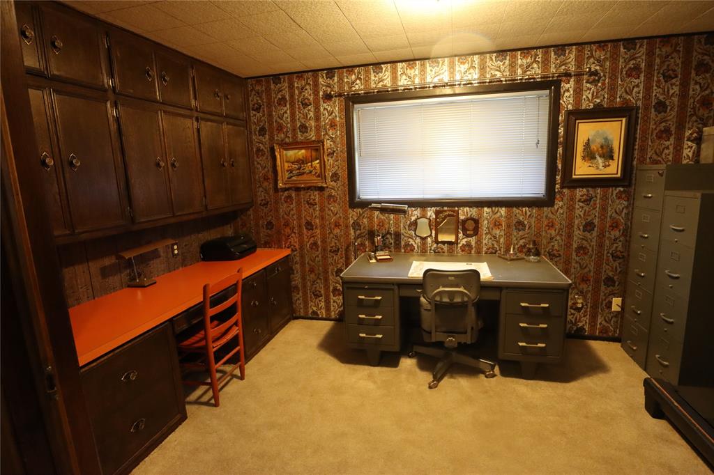 301 Travis Street Ranger, TX 76470 - Photo 24 of 31 a bathroom with a sink vanity and mirror