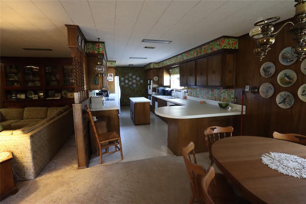 301 Travis Street Ranger, TX 76470 - Photo 25 of 31 a living room with stainless steel appliances furniture a rug and a kitchen