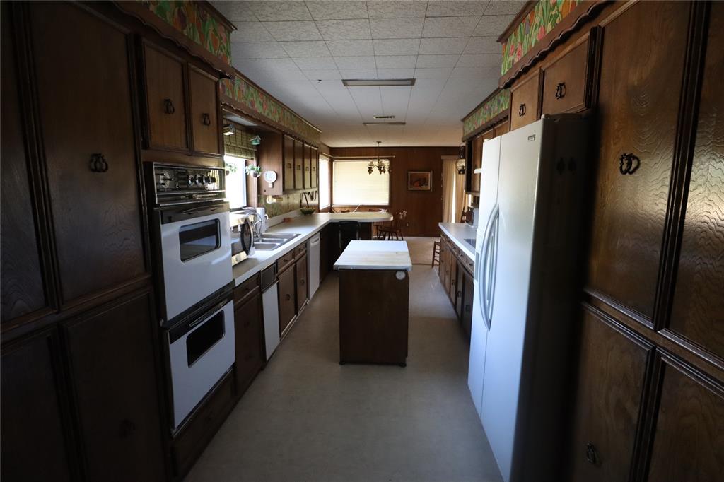301 Travis Street Ranger, TX 76470 - Photo 28 of 31 a kitchen with stainless steel appliances granite countertop a refrigerator and a stove