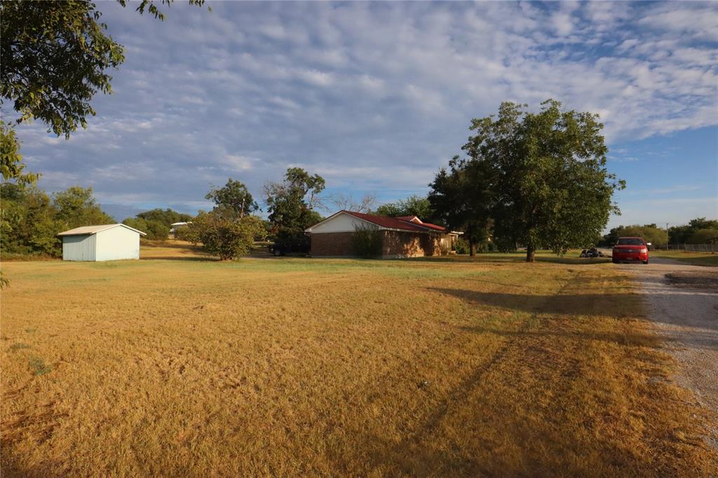 301 Travis Street Ranger, TX 76470 - Photo 3 of 31 a street view with large trees