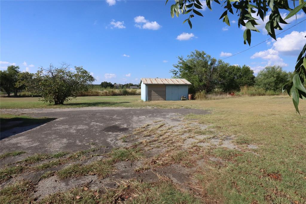 301 Travis Street Ranger, TX 76470 - Photo 7 of 31 a view of a yard with an outdoor space