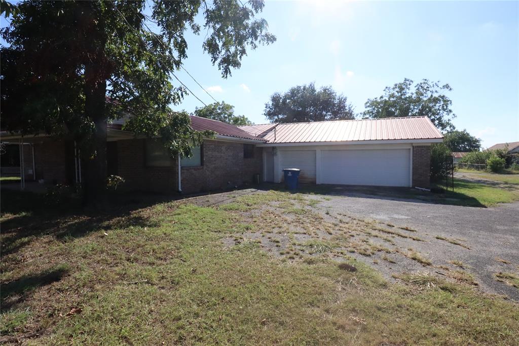 301 Travis Street Ranger, TX 76470 - Photo 8 of 31 a house with a yard