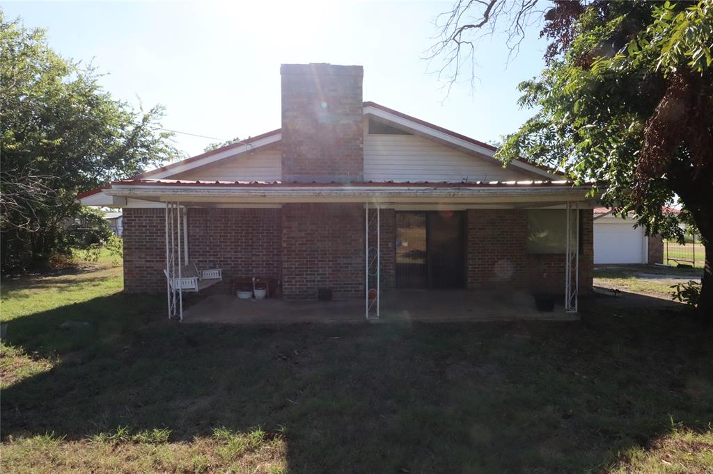 301 Travis Street Ranger, TX 76470 - Photo 9 of 31 a front view of a house with a yard and garage