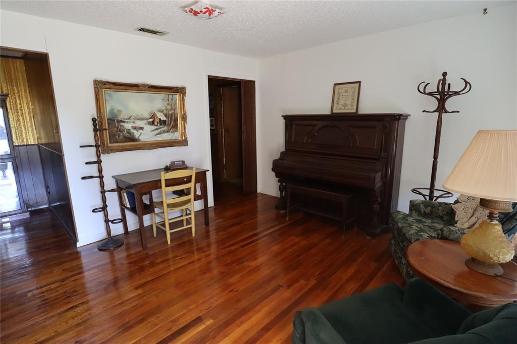 301 Travis Street Ranger, TX 76470 - Photo 10 of 31 a living room with furniture and a wooden floor