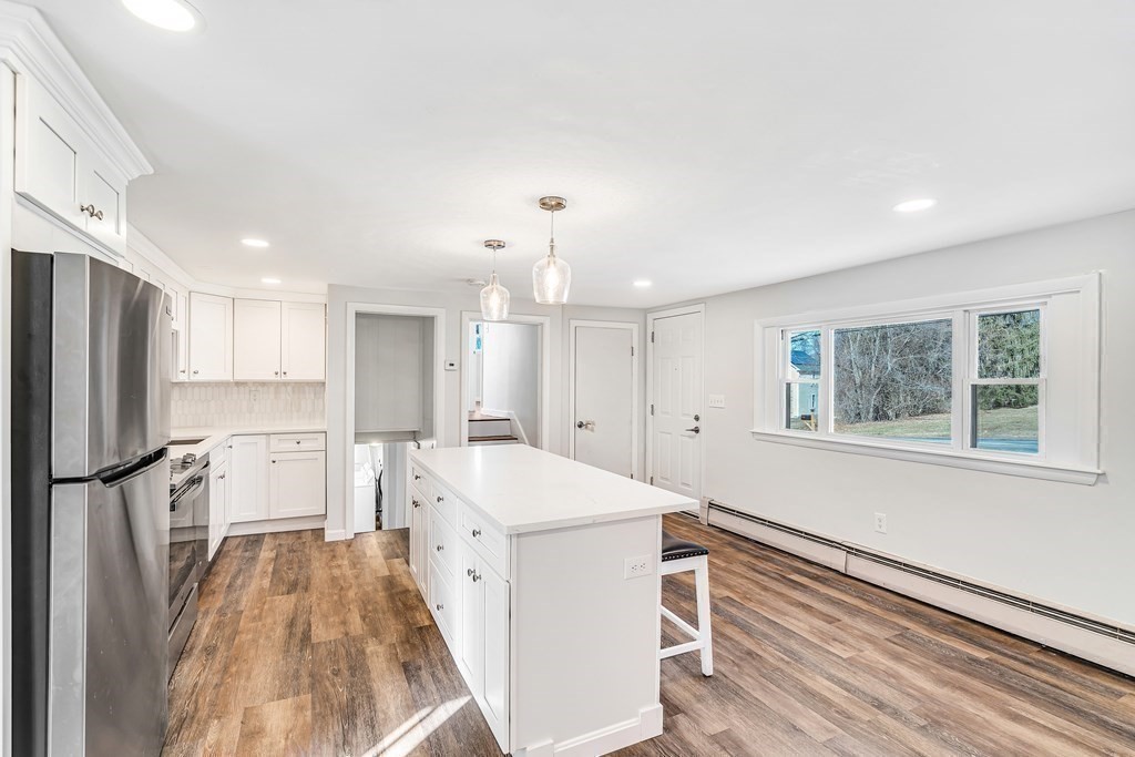 340 Berlin Road Marlborough, MA 01752 - Photo 17 of 42 a kitchen with a refrigerator a sink and dishwasher with wooden floor