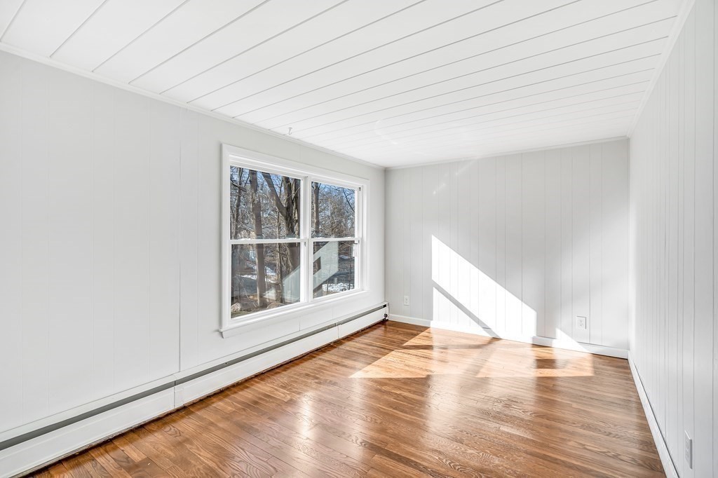 340 Berlin Road Marlborough, MA 01752 - Photo 20 of 42 a view of an empty room with wooden floor and a window