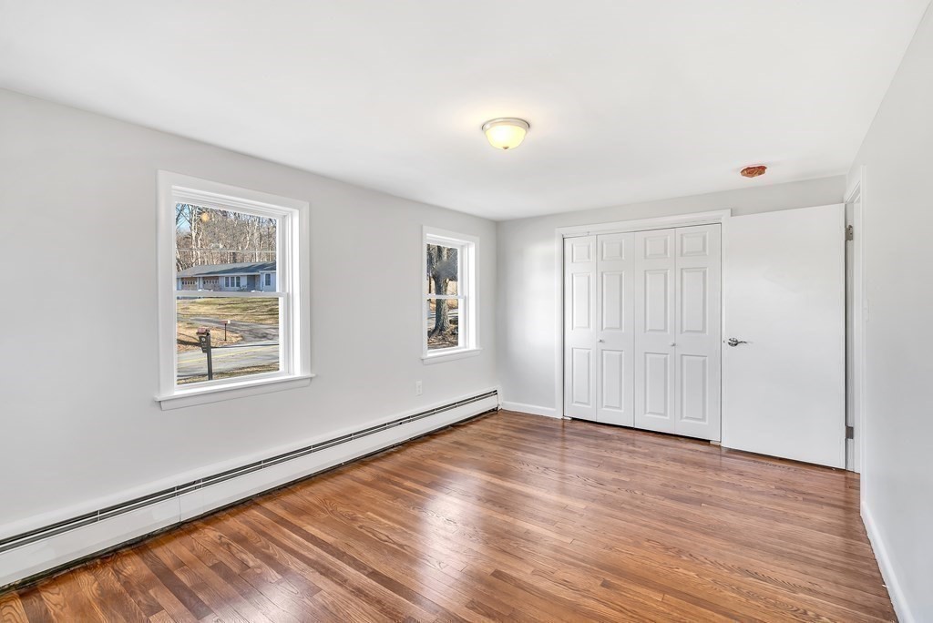 340 Berlin Road Marlborough, MA 01752 - Photo 27 of 42 a view of an empty room with wooden floor and a window