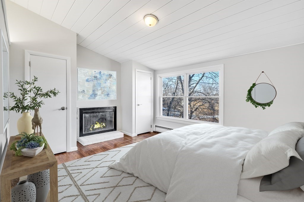 340 Berlin Road Marlborough, MA 01752 - Photo 5 of 42 a bedroom with bed and a fireplace