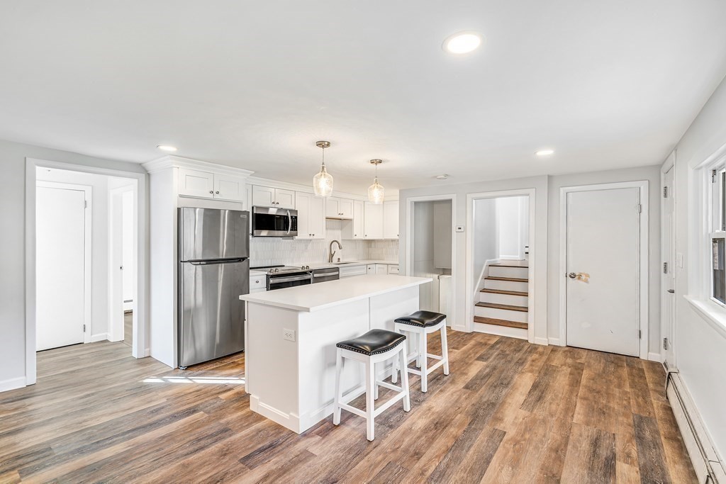 340 Berlin Road Marlborough, MA 01752 - Photo 7 of 42 a kitchen with stainless steel appliances a refrigerator and wooden floor
