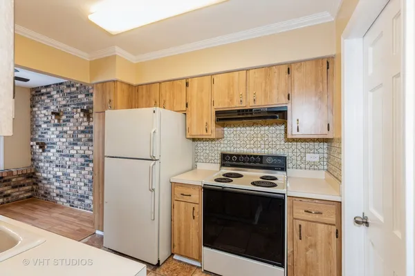 a kitchen with a refrigerator and a stove