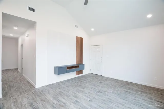 a view of a hallway with wooden floor