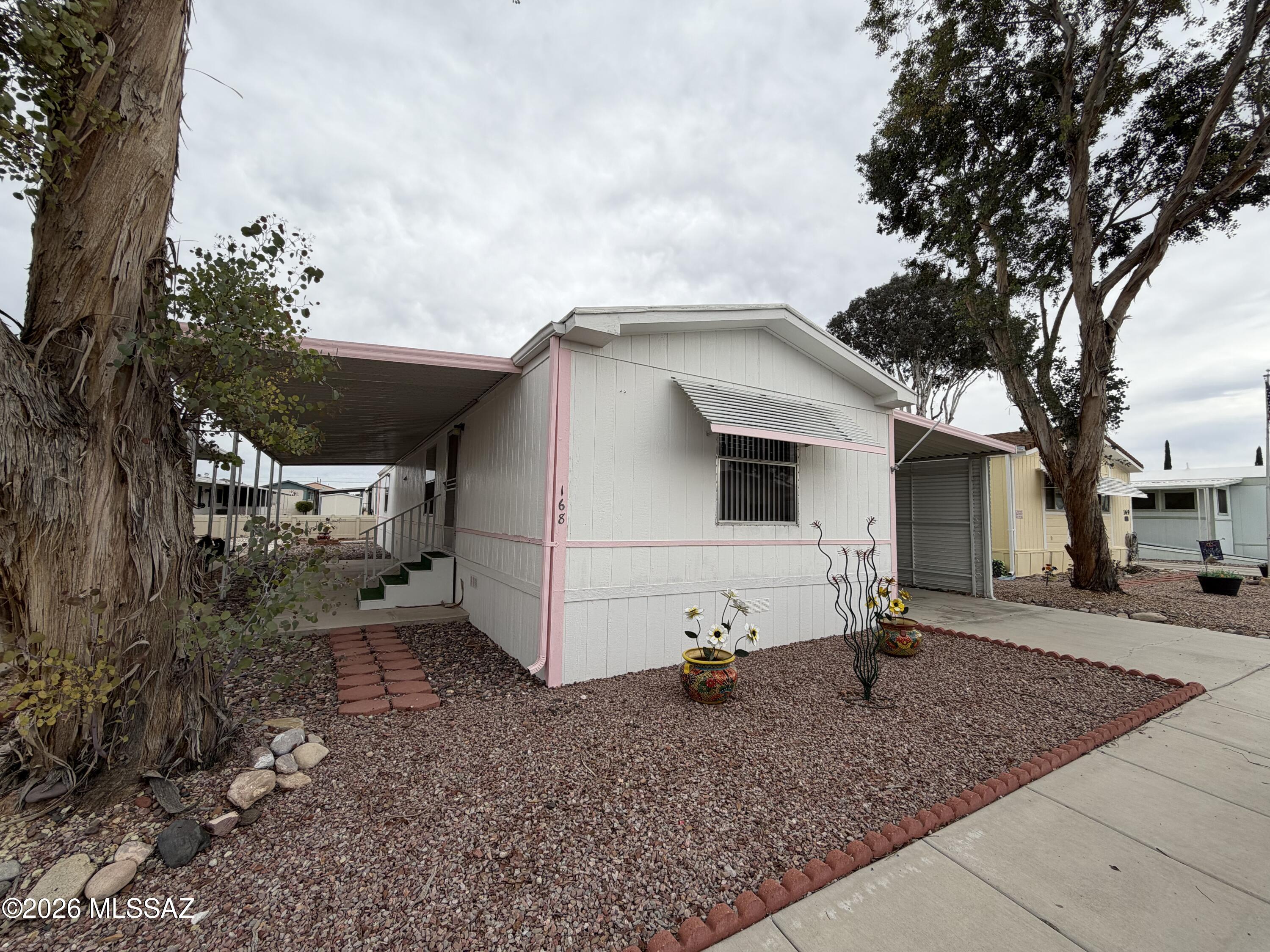 8401 South Kolb Road, Unit 168 Tucson, AZ 85756 - Photo 1 of 20 a view of a white house with a sink and backyard