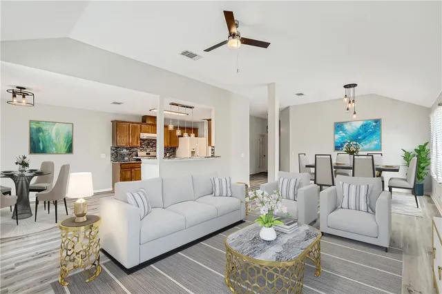 a living room with furniture and wooden floor