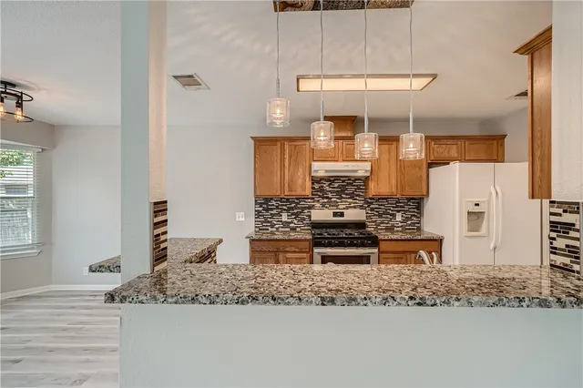 a kitchen with a sink stove and cabinets