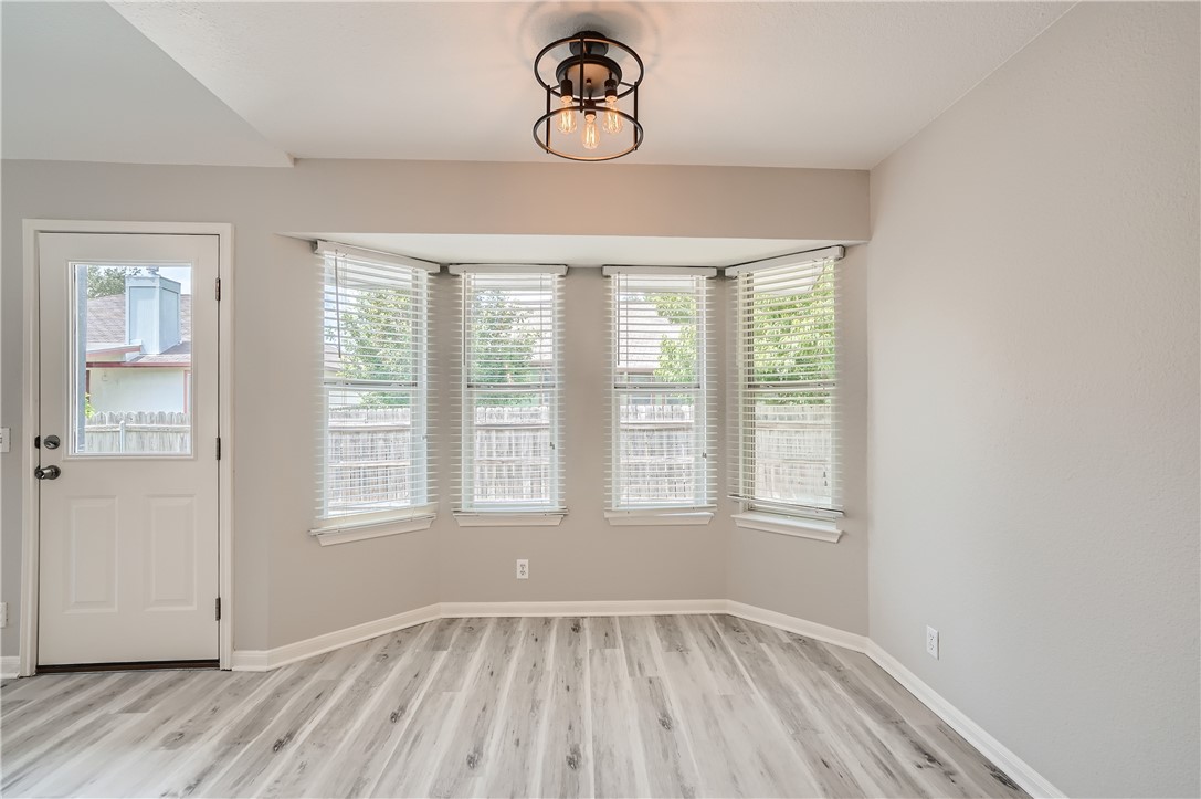 102 Evergreen Circle Georgetown, TX 78626 - Photo 15 of 33 an empty room with wooden floor and windows