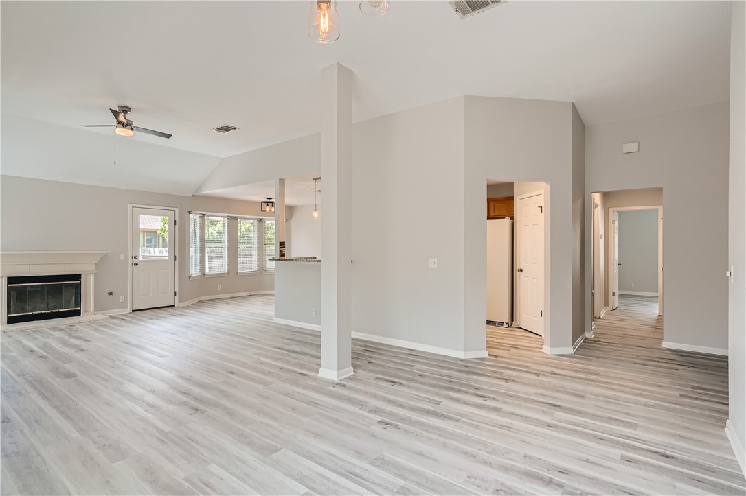 102 Evergreen Circle Georgetown, TX 78626 - Photo 16 of 33 an empty room with wooden floor fireplace and windows