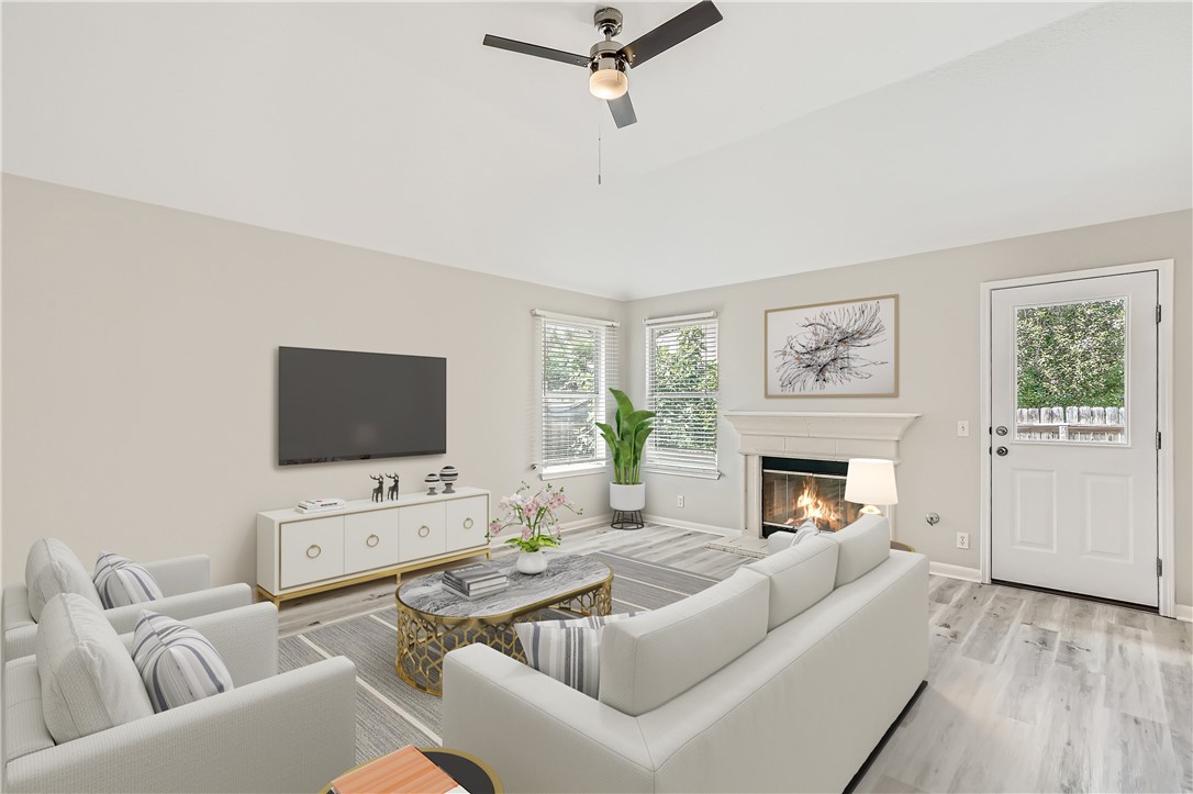 102 Evergreen Circle Georgetown, TX 78626 - Photo 2 of 33 a living room with furniture a fireplace a flat screen tv and a window
