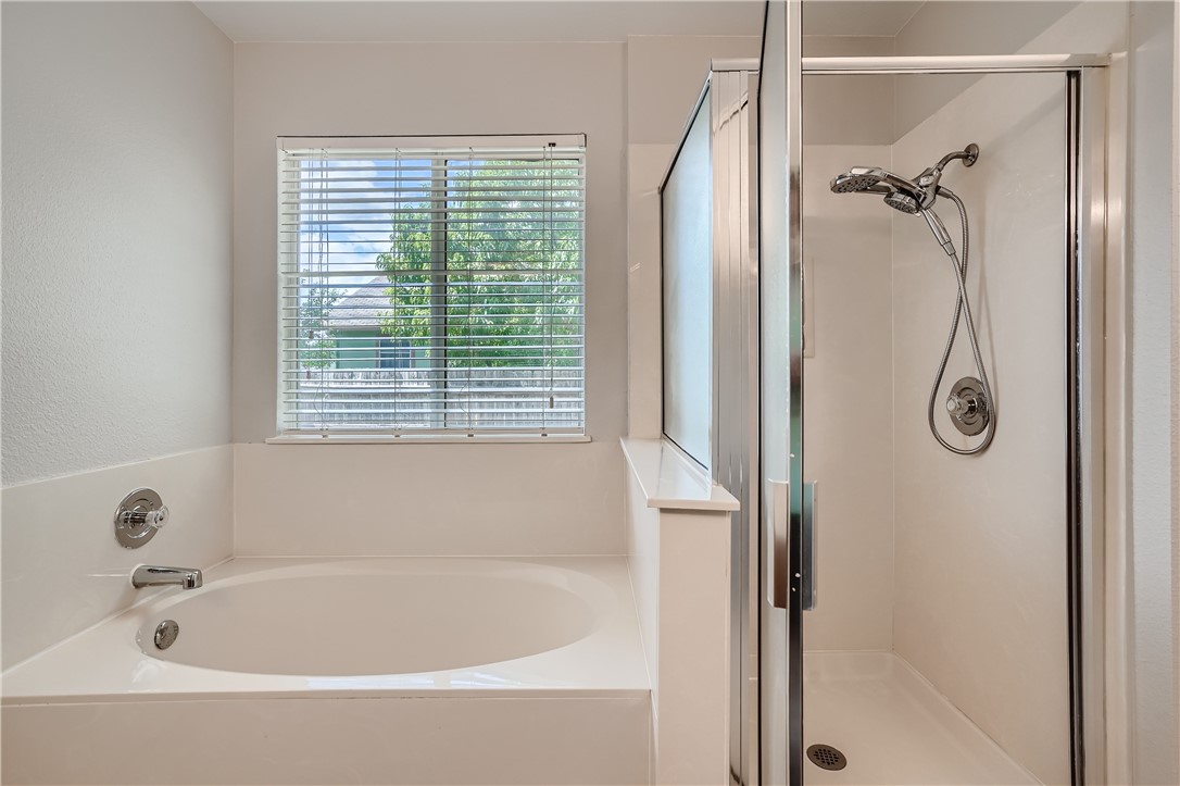 102 Evergreen Circle Georgetown, TX 78626 - Photo 21 of 33 a white bath tub sitting next to a shower