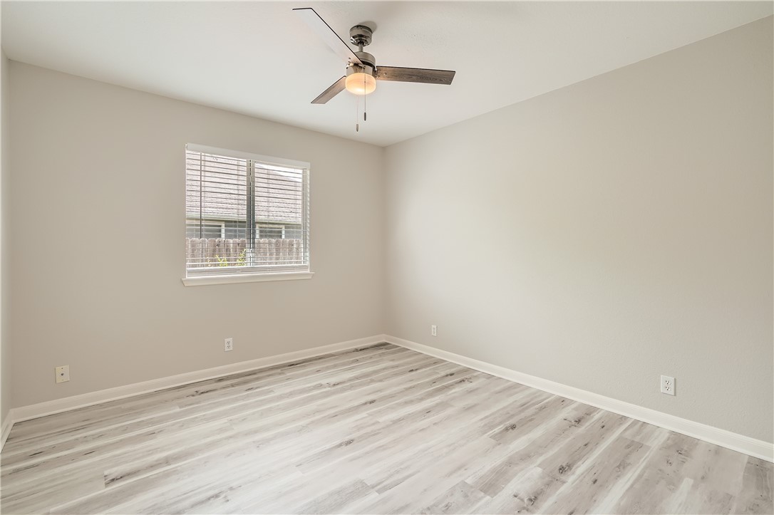 102 Evergreen Circle Georgetown, TX 78626 - Photo 25 of 33 wooden floor in an empty room with a window