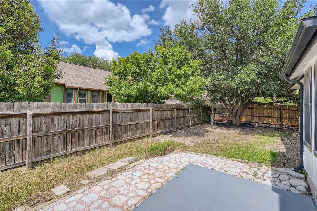 102 Evergreen Circle Georgetown, TX 78626 - Photo 29 of 33 a view of a backyard with a large tree and wooden fence