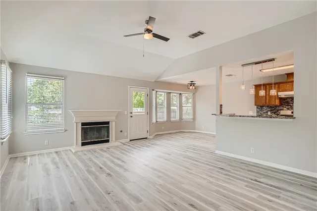 a view of main area fire place window and wooden floor