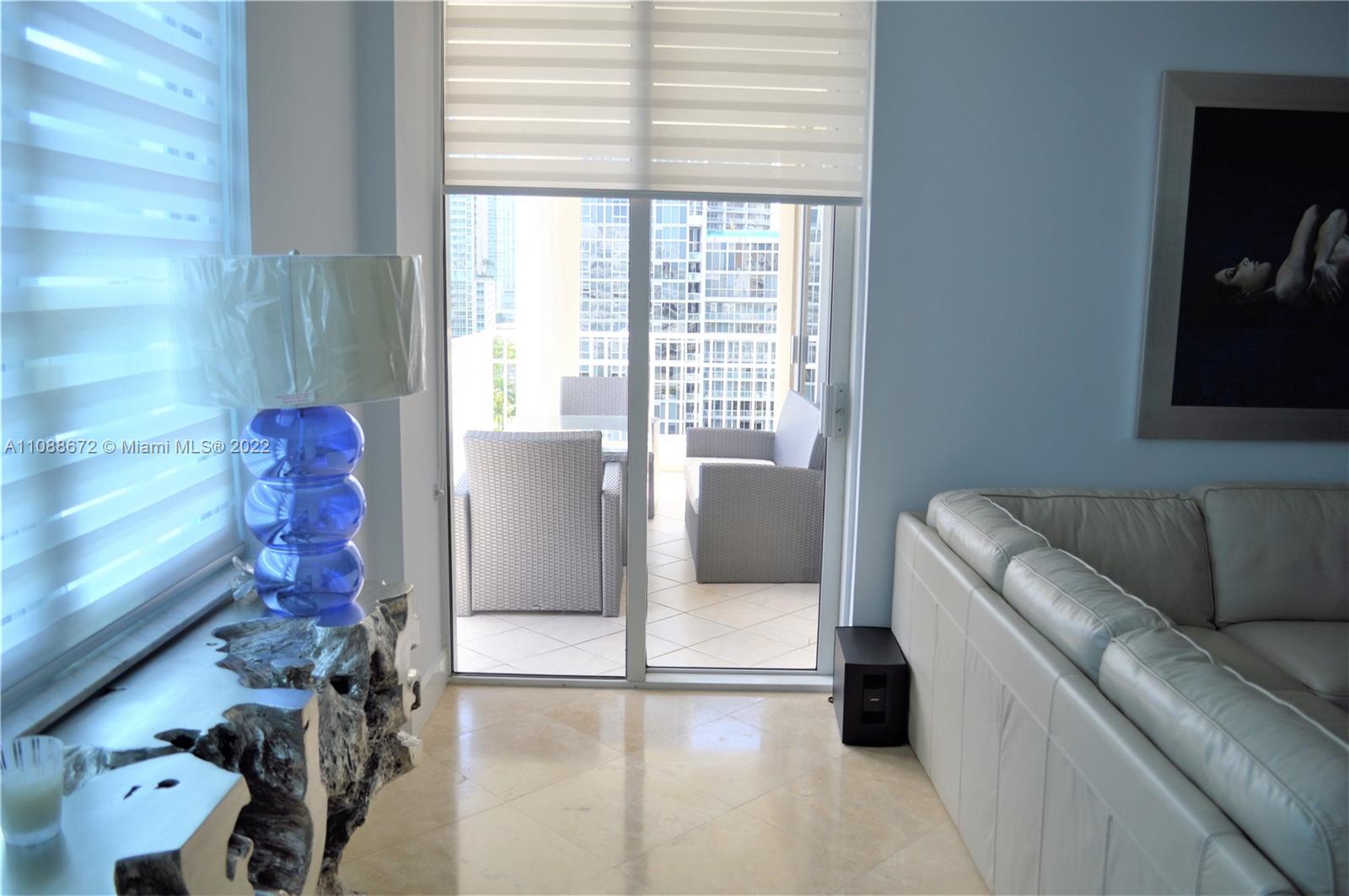 701 Brickell Key Boulevard, Unit 1203 Miami, FL 33131 - Photo 13 of 34 a living room with furniture and a window