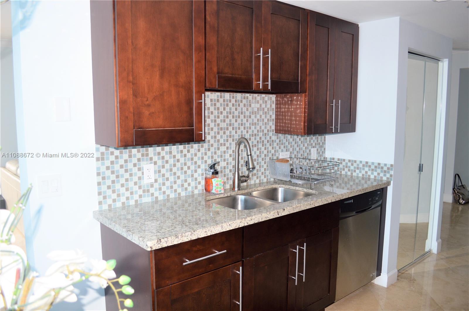 701 Brickell Key Boulevard, Unit 1203 Miami, FL 33131 - Photo 16 of 34 a bathroom with a sink and a mirror