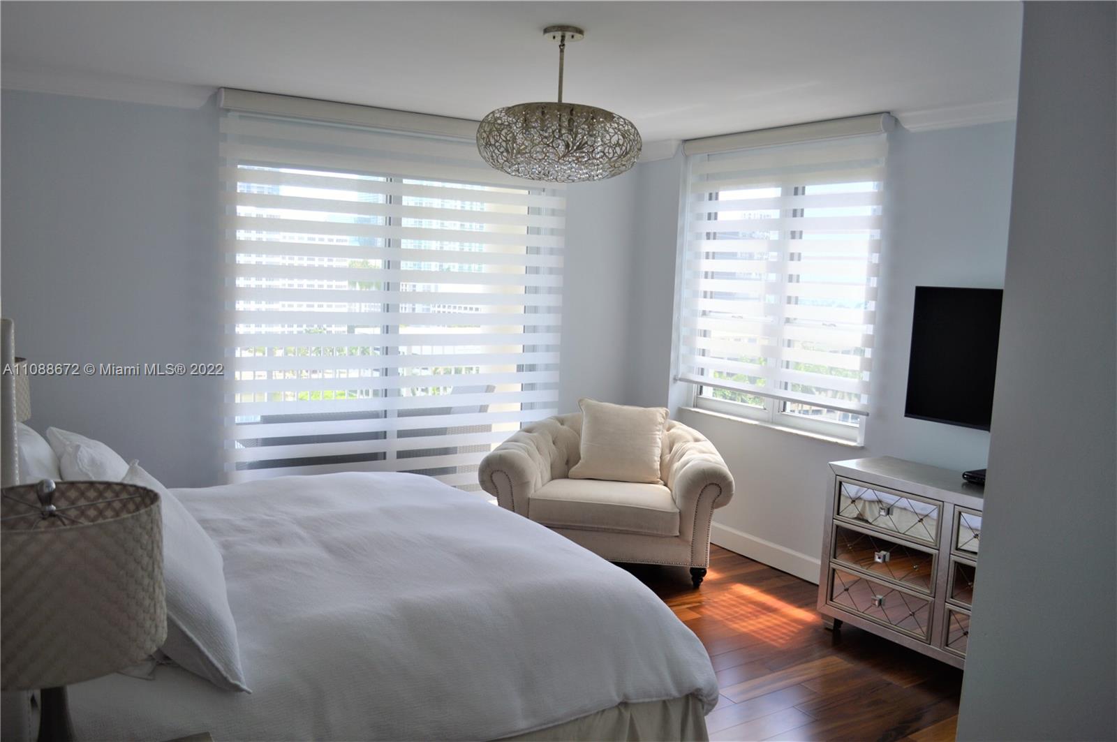 701 Brickell Key Boulevard, Unit 1203 Miami, FL 33131 - Photo 21 of 34 a bedroom with a bed and a flat screen tv