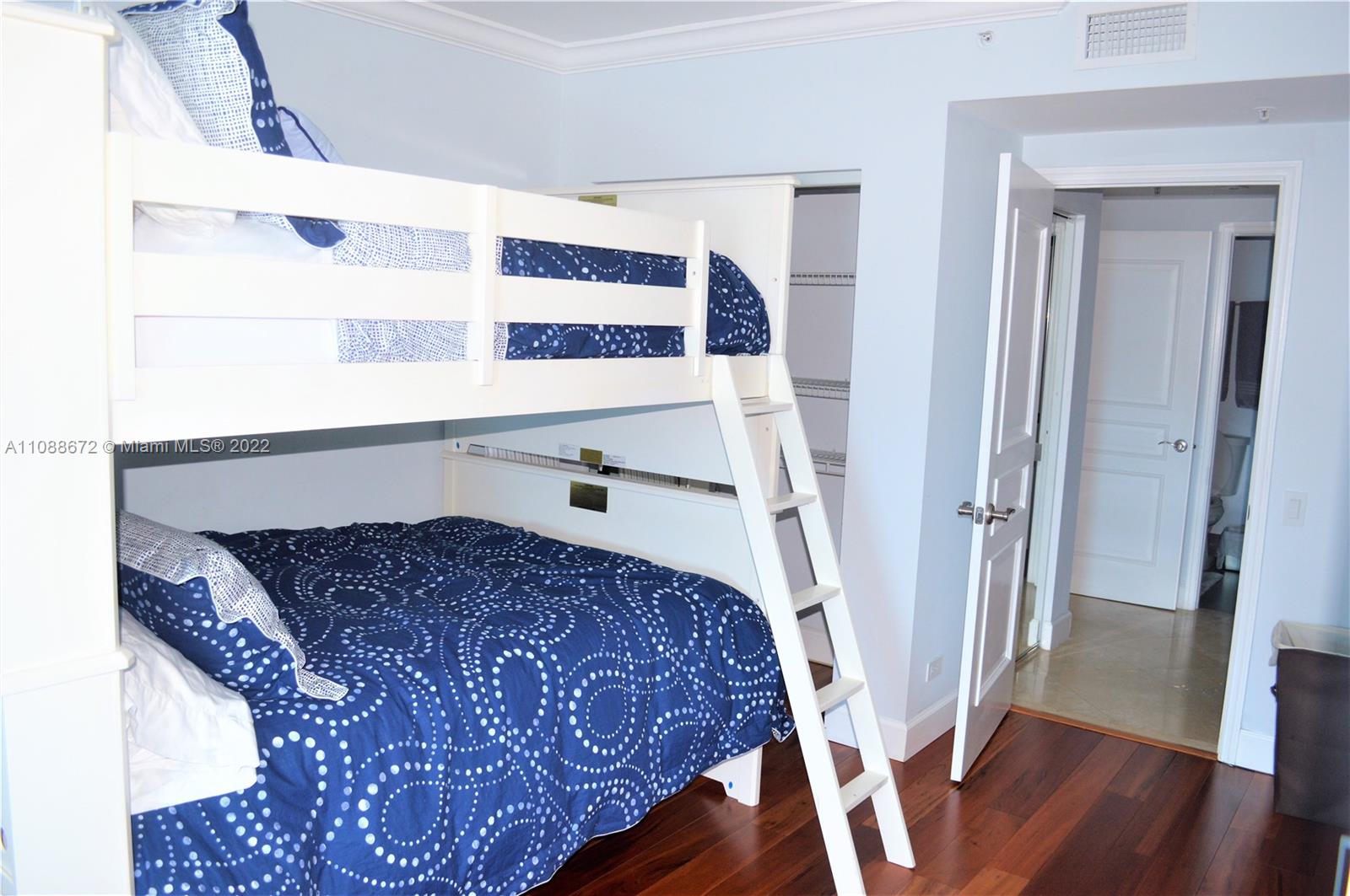 701 Brickell Key Boulevard, Unit 1203 Miami, FL 33131 - Photo 22 of 34 a bedroom with a bed and wooden floor