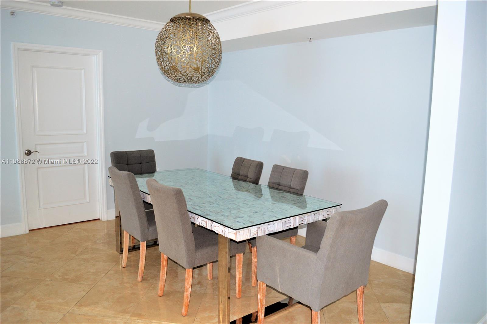 701 Brickell Key Boulevard, Unit 1203 Miami, FL 33131 - Photo 3 of 34 a view of a dining room with furniture and wooden floor
