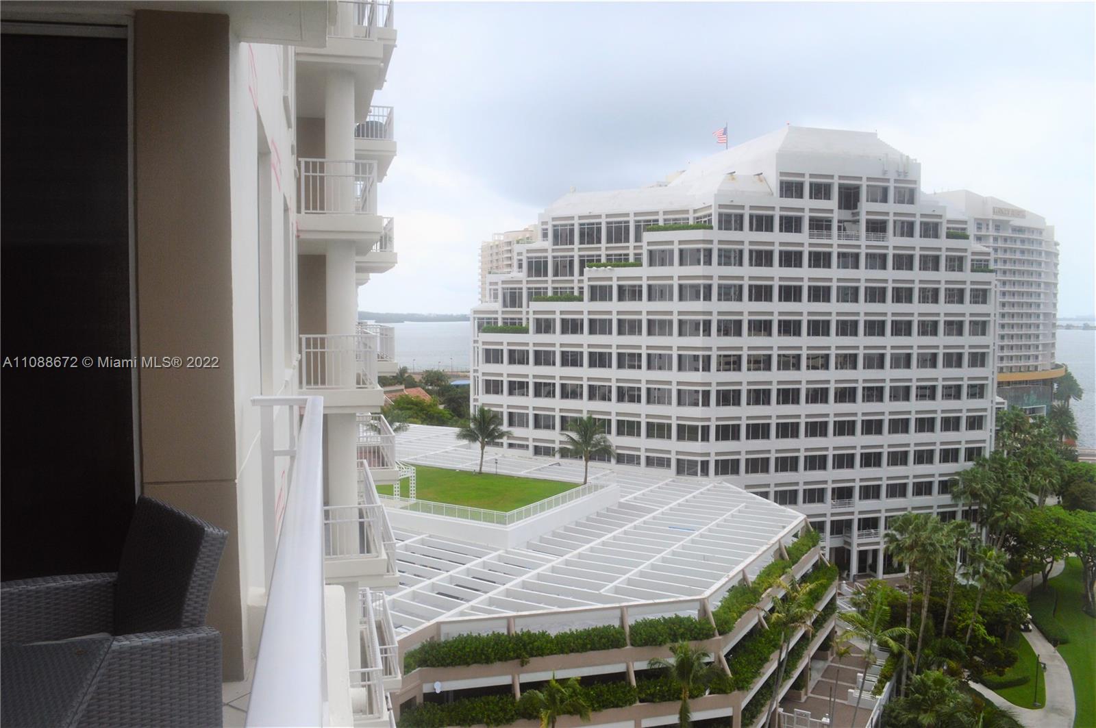 701 Brickell Key Boulevard, Unit 1203 Miami, FL 33131 - Photo 33 of 34 a view of a balcony with a table and chairs