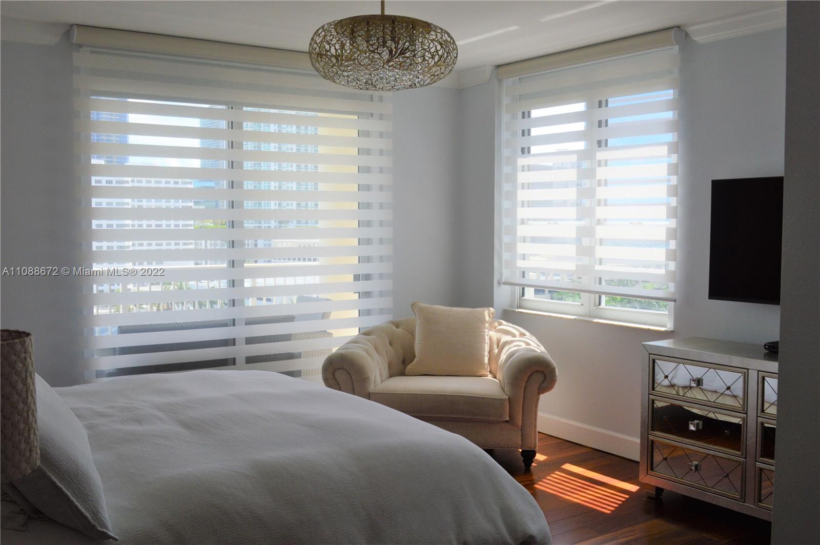 701 Brickell Key Boulevard, Unit 1203 Miami, FL 33131 - Photo 6 of 34 a bedroom with a bed and a television