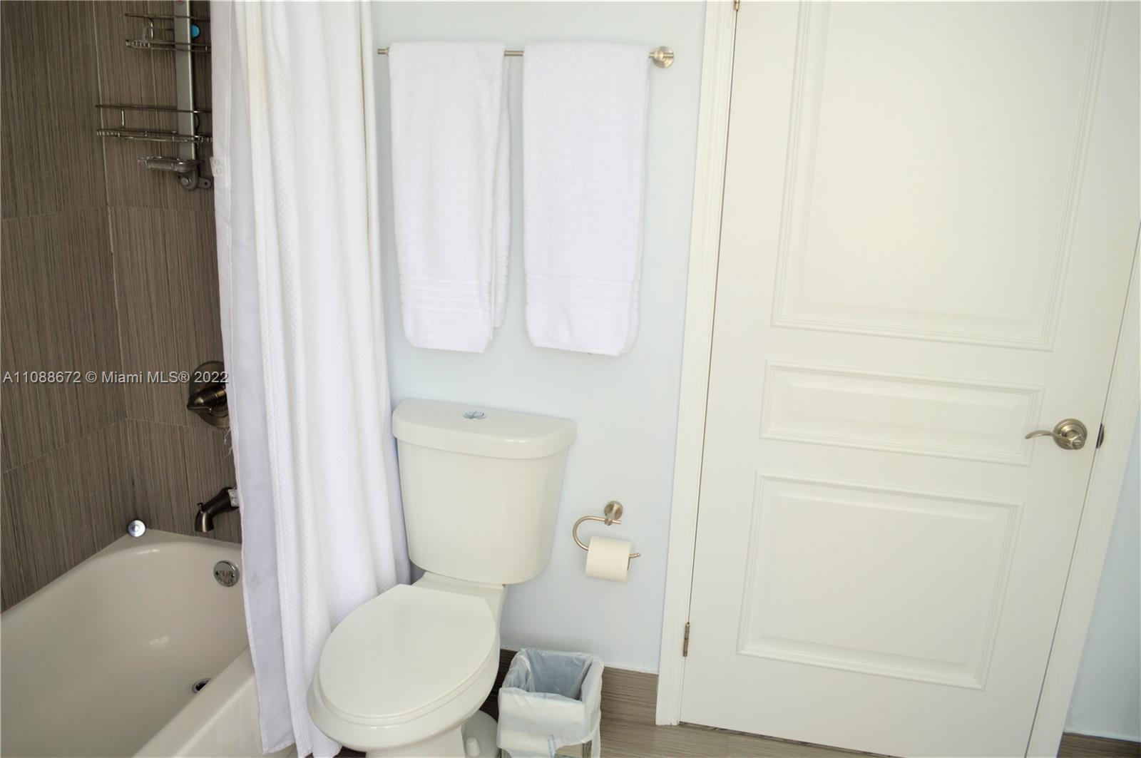 701 Brickell Key Boulevard, Unit 1203 Miami, FL 33131 - Photo 8 of 34 a white toilet sitting next to a bathroom sink