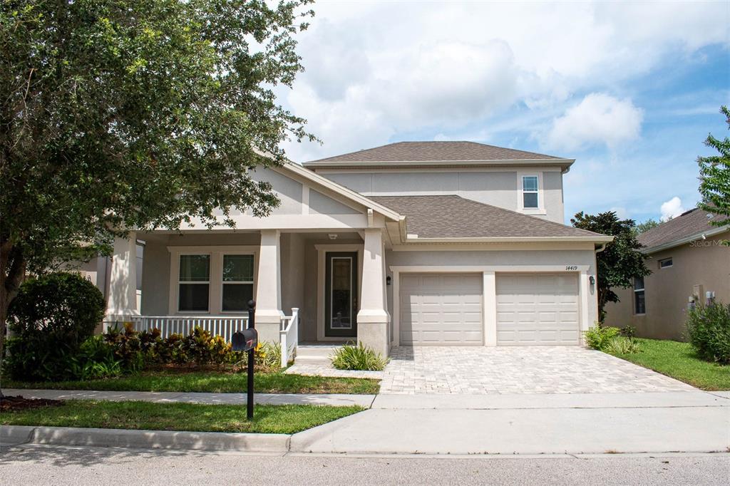 14419 Magnolia Ridge Loop Winter Garden, FL 34787 - Photo 1 of 1 a front view of a house with a yard
