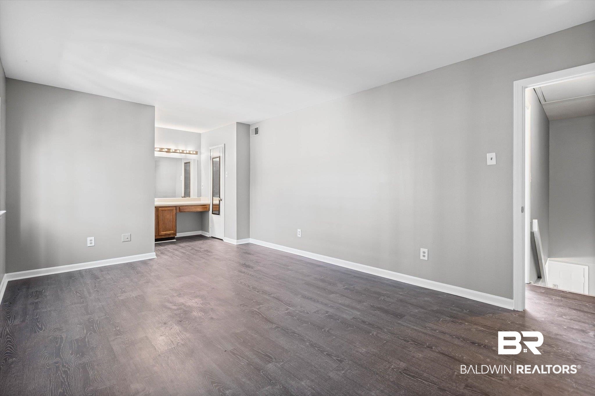 6701 Dickens Ferry Road, Unit 100 Mobile, AL 36608 - Photo 15 of 24 Unfurnished living room with dark wood-style flooring and baseboards