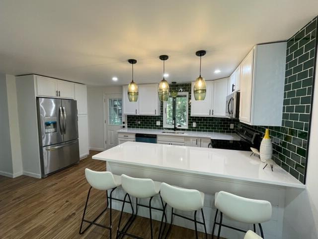 25 Hayes Road Centerville, MA 02632 - Photo 7 of 29 a large kitchen with a table and chairs