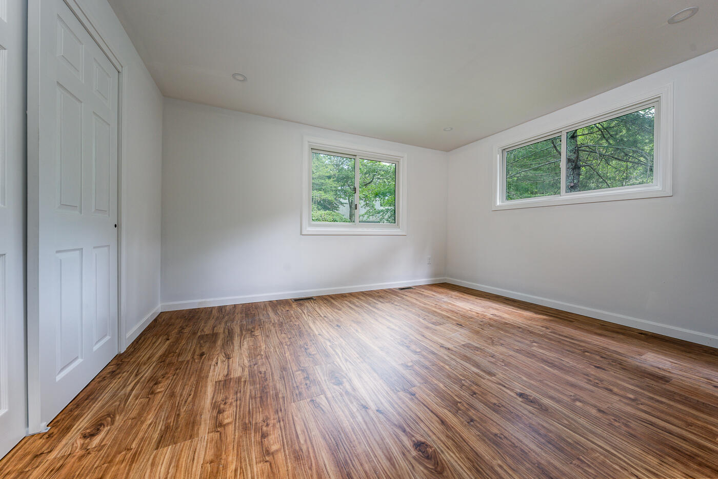 25 Hayes Road Centerville, MA 02632 - Photo 8 of 29 a view of an empty room with wooden floor and a window