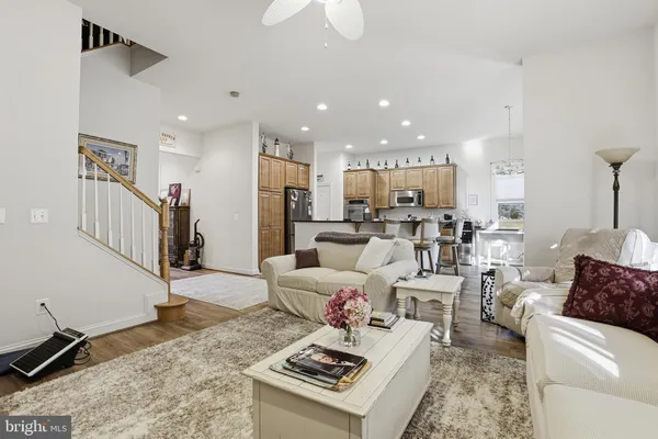 a living room with lots of furniture and kitchen view