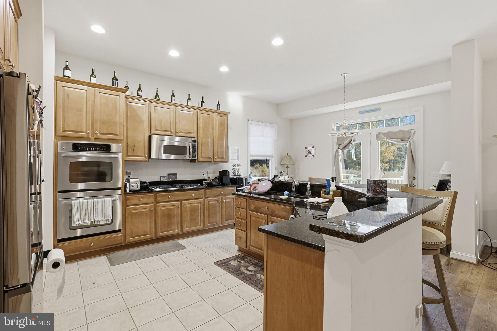 40 Branson Cove Road Hague, VA 22469 - Photo 12 of 51 a kitchen with stainless steel appliances granite countertop a stove top oven a sink refrigerator and cabinets