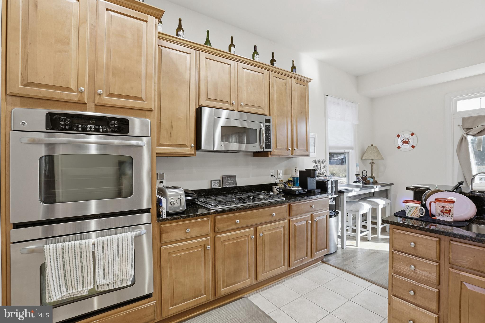40 Branson Cove Road Hague, VA 22469 - Photo 14 of 51 a kitchen with stainless steel appliances granite countertop a stove a sink and a microwave