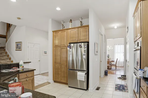 a kitchen with stainless steel appliances a refrigerator and a stove top oven