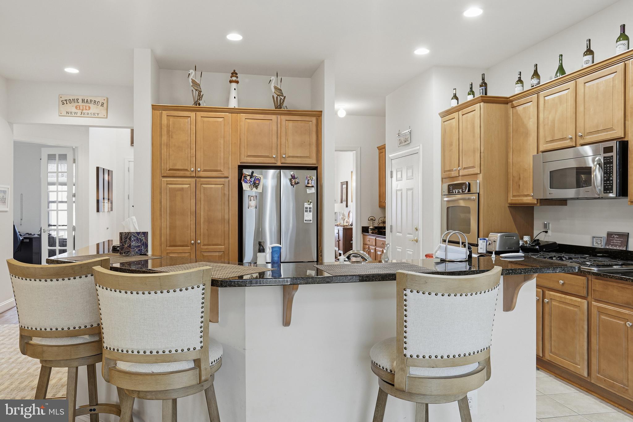 40 Branson Cove Road Hague, VA 22469 - Photo 16 of 51 a kitchen with stainless steel appliances granite countertop a sink a stove and chairs
