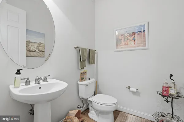 a bathroom with a sink mirror and toilet