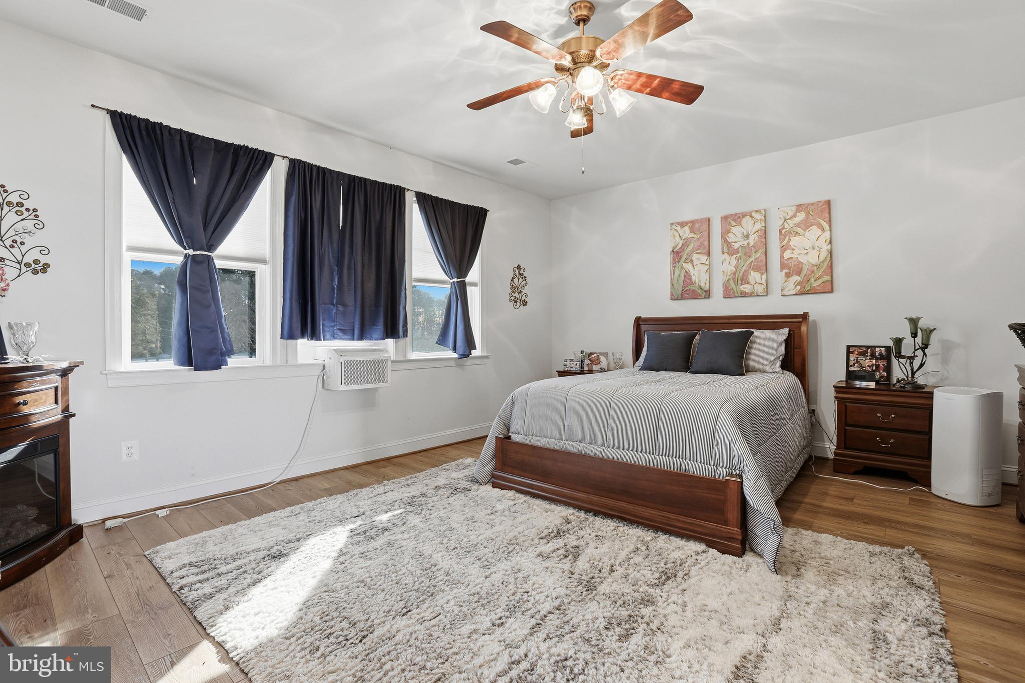 40 Branson Cove Road Hague, VA 22469 - Photo 20 of 51 a bedroom with a large bed and a chandelier