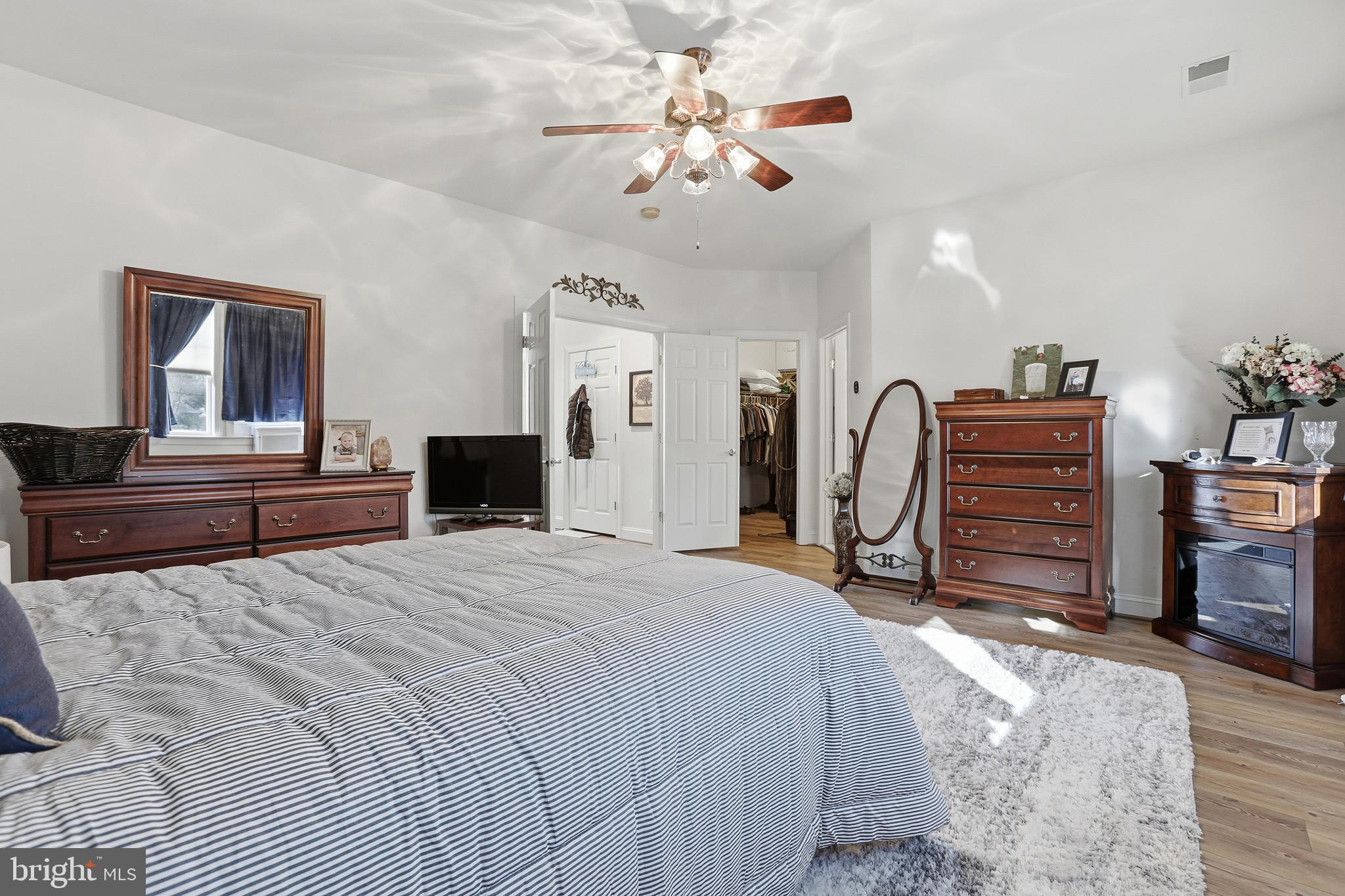 40 Branson Cove Road Hague, VA 22469 - Photo 22 of 51 a bedroom with a bed and a chandelier
